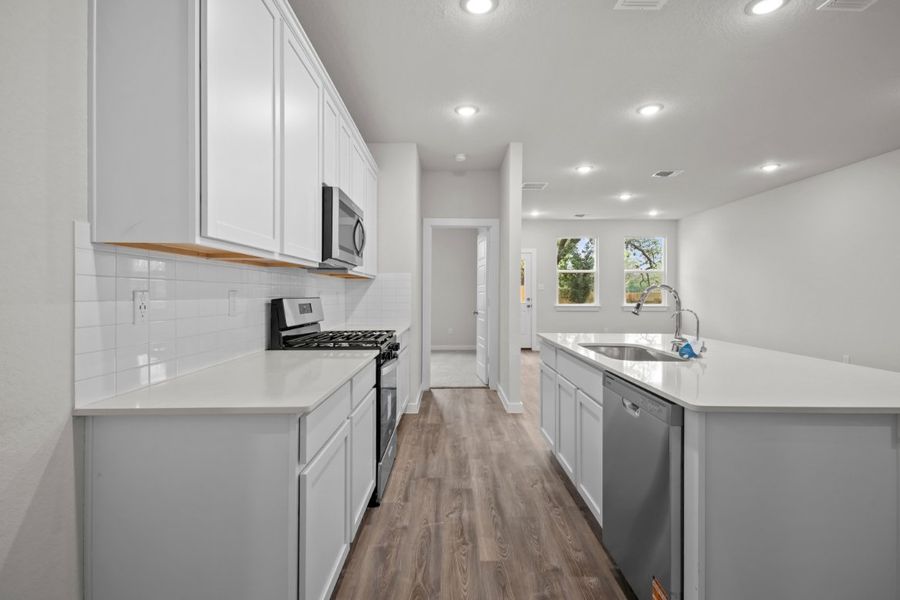 A kitchen with white cabinets.