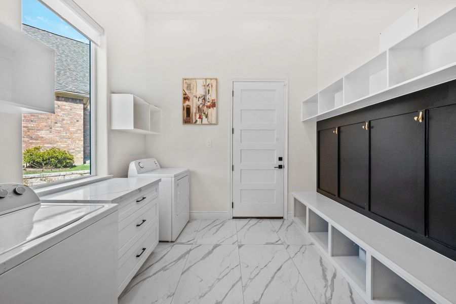 Laundry room with built-ins and mud room right as you enter from the garage.