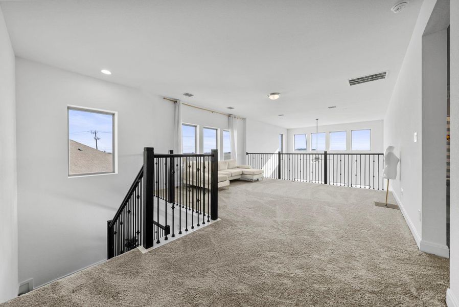 Hall featuring carpet floors and an upstairs landing