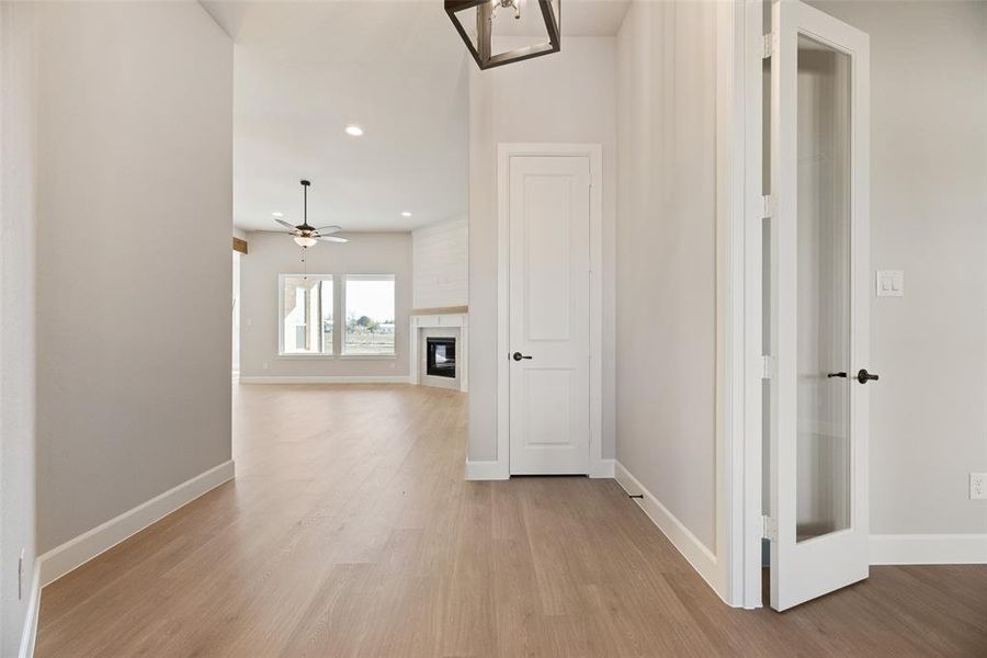 Hall featuring recessed lighting and light wood-style floors Hall featuring recessed lighting and light wood-style floors
