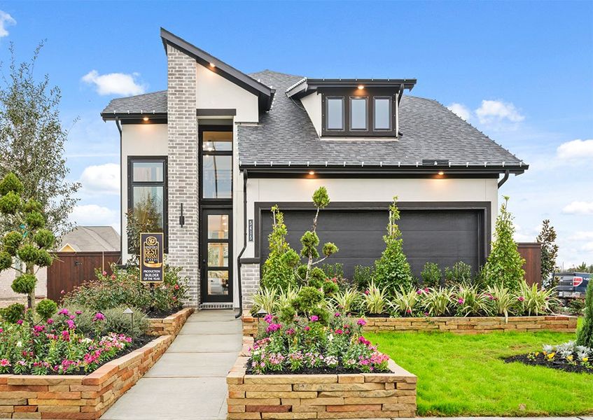 Front exterior of a new home in Meridiana 40', 65', Manvel, TX, highlighting curb appeal (Image 2).