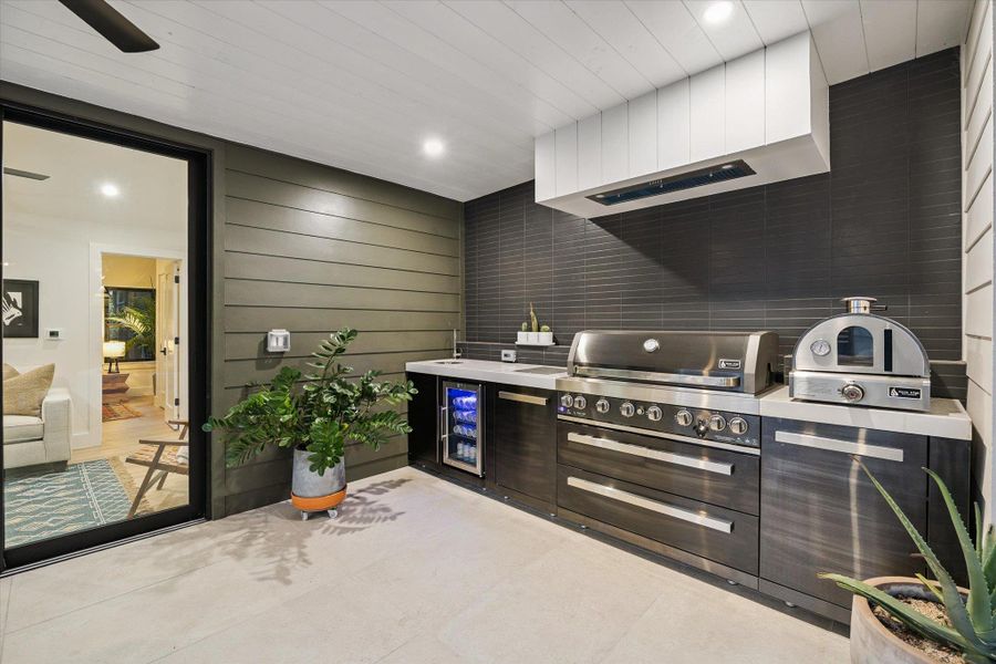 View of patio / terrace featuring beverage cooler and area for grilling View of patio / terrace featuring beverage cooler and area for grilling