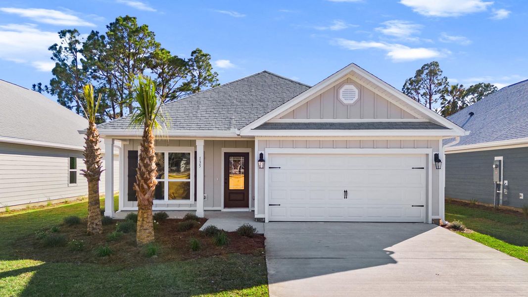 Front exterior of a new home in Caballeros Estates At Hombre, Panama City Beach, FL, highlighting curb appeal (Image 1).