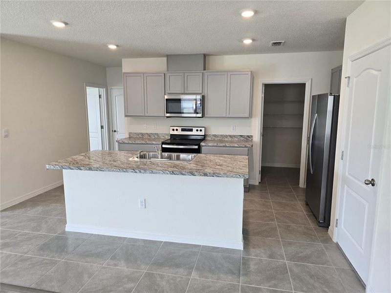 Furnished interior view inside a new home in Charles Cove Express, Davenport (Image 7).