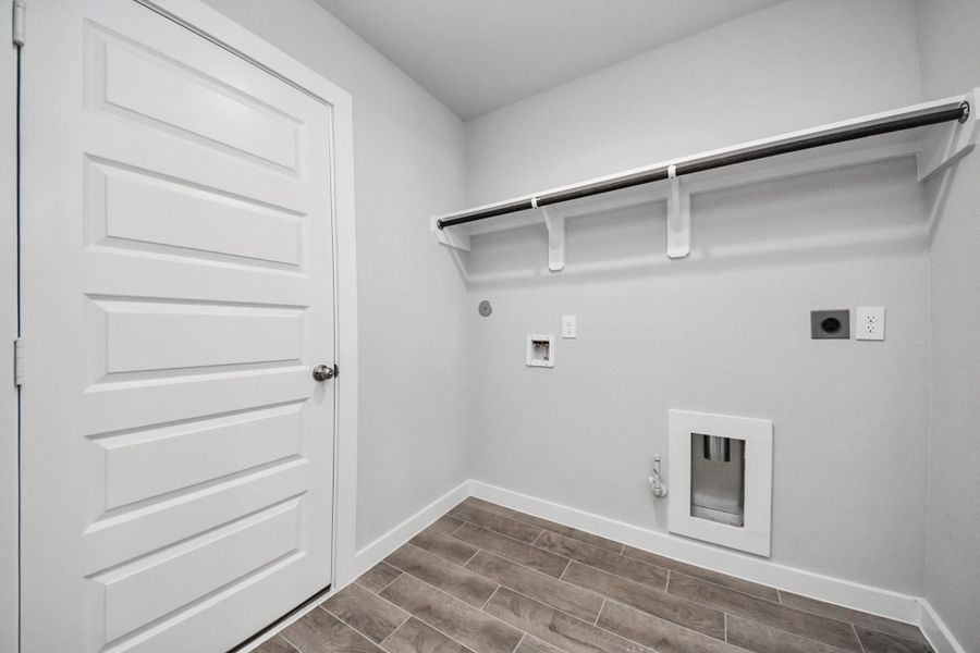 A perfect blend of functionality and comfort. Capture the essence of easy living with a first-floor laundry room, thoughtfully equipped with shelving for effortless organization. Both electric and gas connections available. A perfect blend of functionality and comfort. Capture the essence of easy living with a first-floor laundry room, thoughtfully equipped with shelving for effortless organization. Both electric and gas connections available.