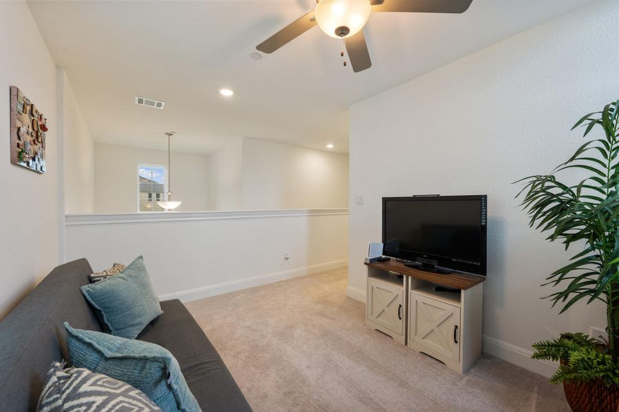 A versatile secondary living space with overhead lighting and plush carpeting for comfortable leisure. A versatile secondary living space with overhead lighting and plush carpeting for comfortable leisure.