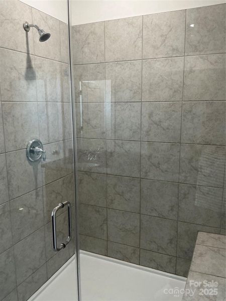 Large tiled shower w/built-in bench seating