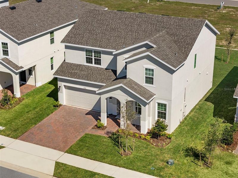 Front exterior of a new home in Trinity Lakes, Groveland, FL, highlighting curb appeal (Image 1).