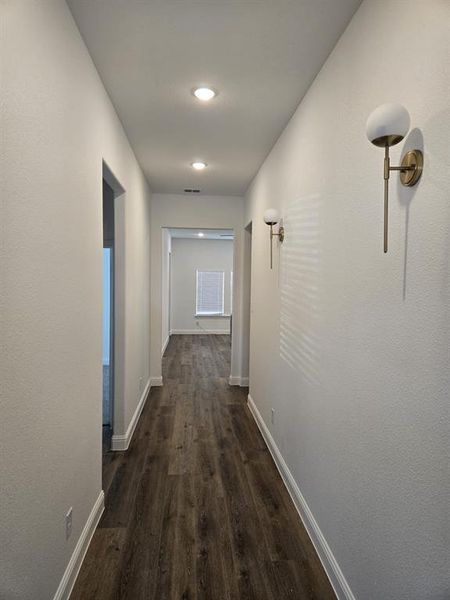 Hall featuring dark wood-style floors and baseboards