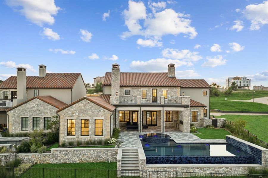 Rear view of property with a patio, a fenced in pool, a balcony, and a yard