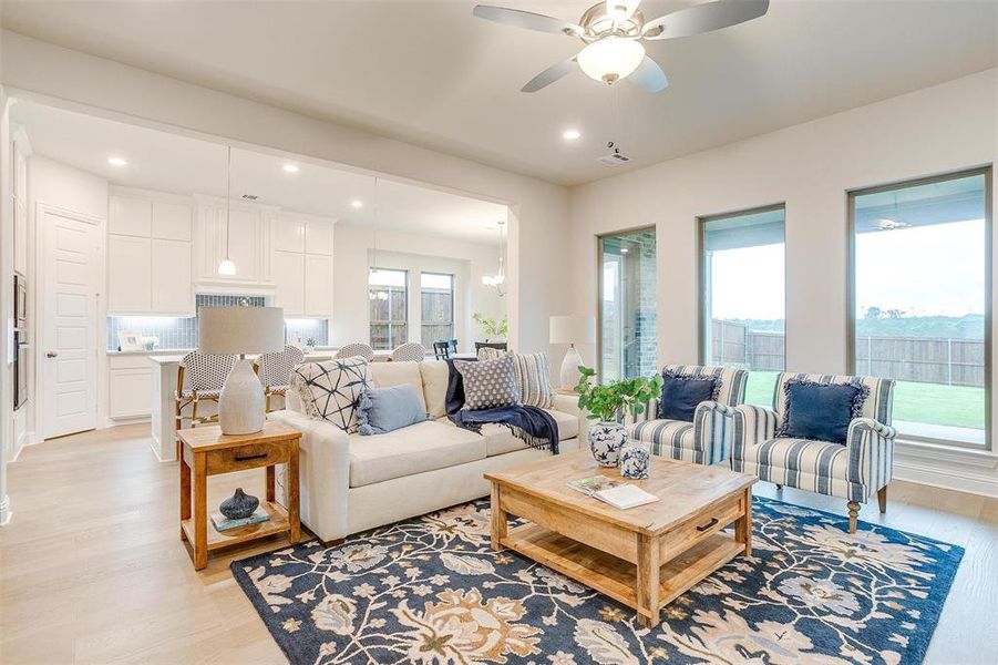 Living room featuring light hardwood / wood-style flooring and ceiling fan