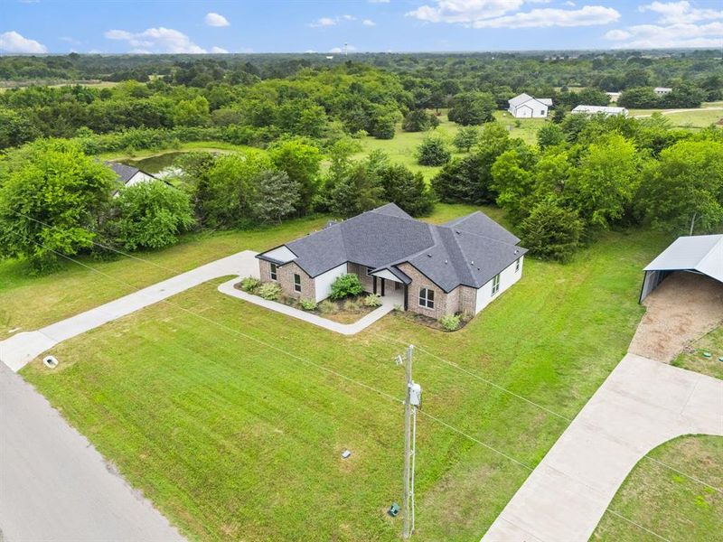 Front exterior of a new home in , Greenville, TX, highlighting curb appeal (Image 23).