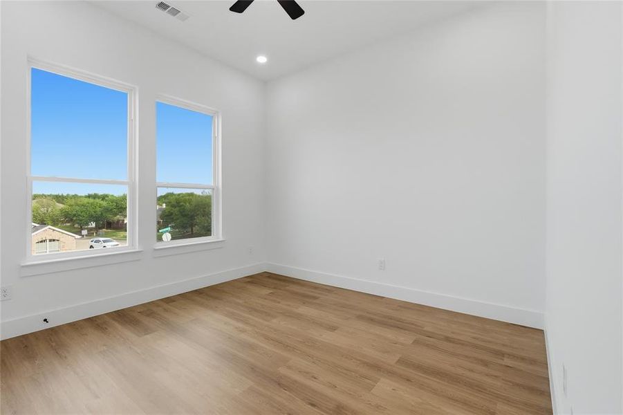 Empty room with light wood-style flooring, a ceiling fan, and recessed lighting