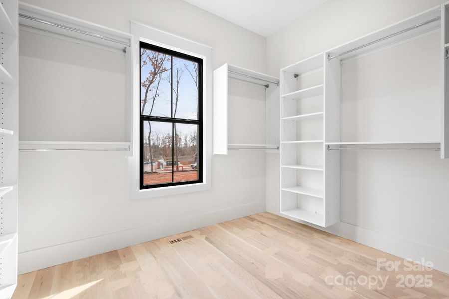 This customized boutique style closet offers exceptional storage, thoughtful organization, and an elegant finishing touch to the primary suite.