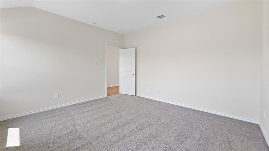 Interior room featuring light gray carpet, neutral wall paint, and white trim molding