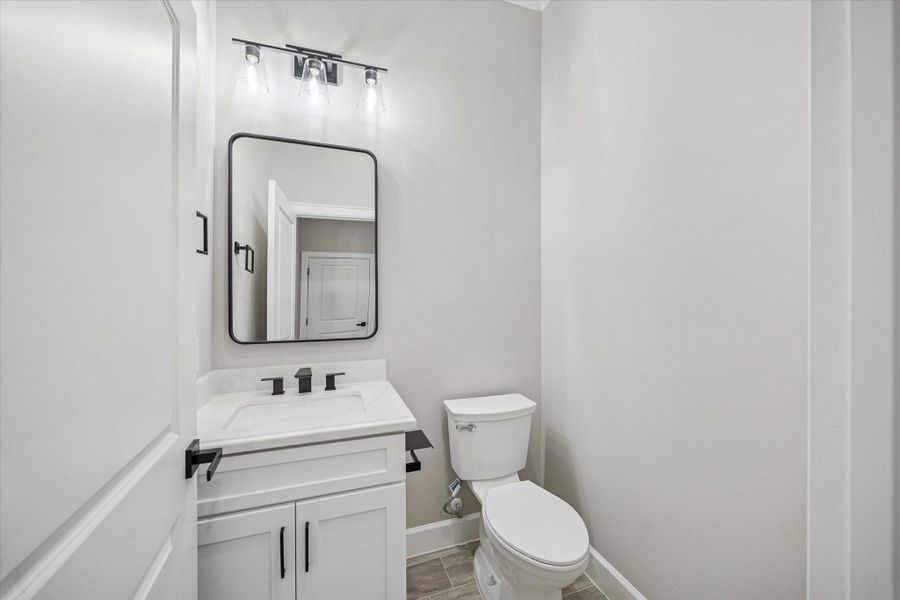 Half bath on hallway from the garage and close to the kitchen.