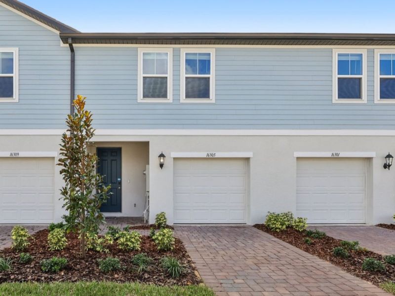 Front exterior of a new home in Cagan Crossings West, Clermont, FL, highlighting curb appeal (Image 1).