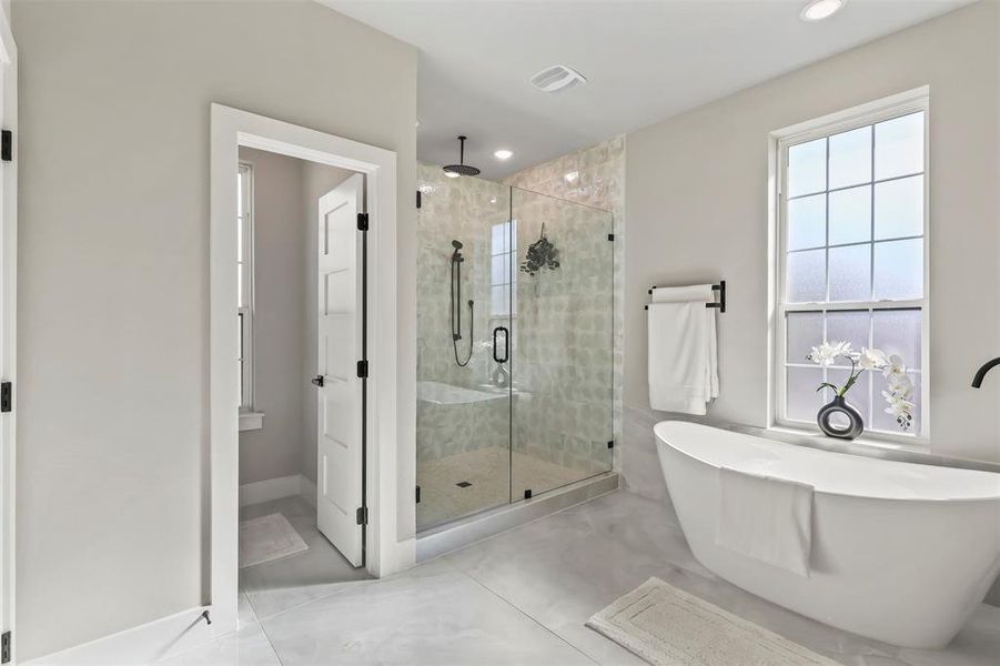 Full bathroom with a freestanding bath and a shower stall Full bathroom with a freestanding bath and a shower stall
