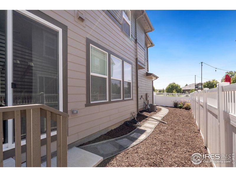 Xeriscaped Back Yard With Tall Maintenance Free Fence Provides Easy Maintenance, but Gives Extra Private Secure Space For BBQ's, Gardens or Lounging.