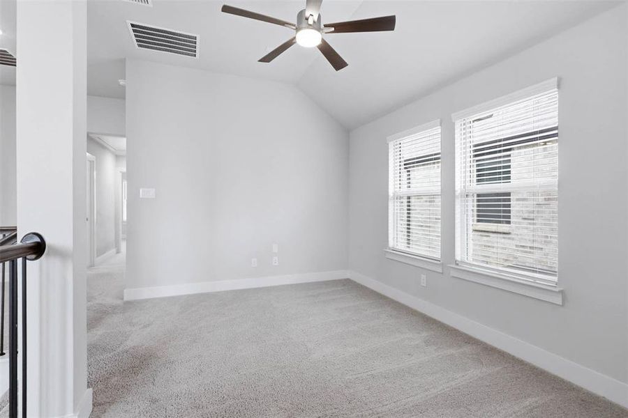 Upstairs landing and game room area with open railing and natural light.