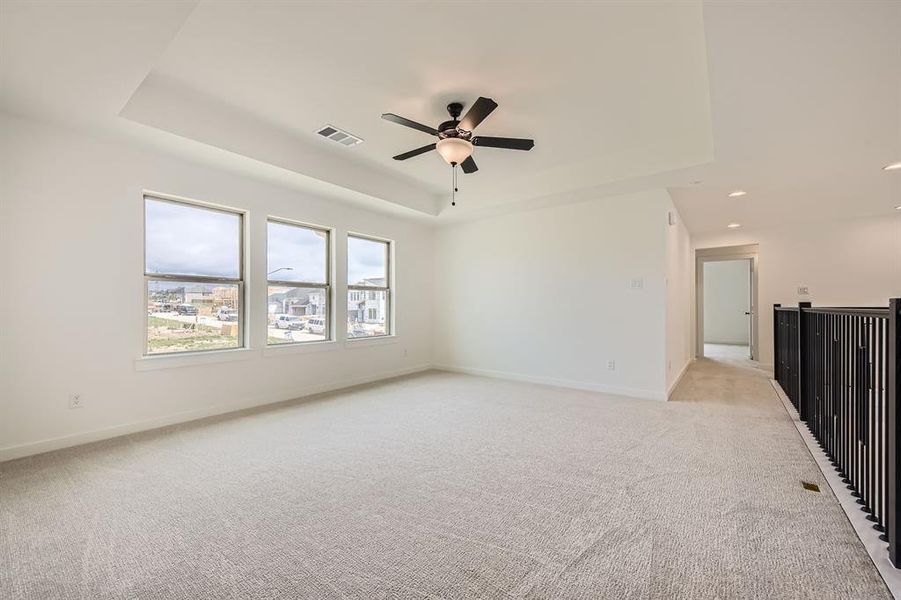 Spare room featuring a tray ceiling, light colored carpet, ceiling fan, and recessed lighting Spare room featuring a tray ceiling, light colored carpet, ceiling fan, and recessed lighting