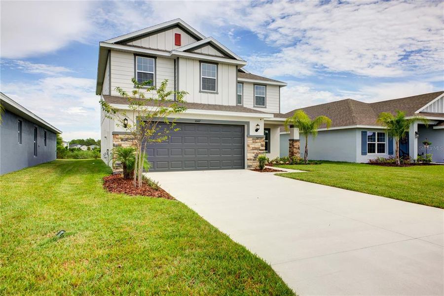 Front exterior of a new home in Aviary at Rutland Ranch, Parrish, FL, highlighting curb appeal (Image 1).
