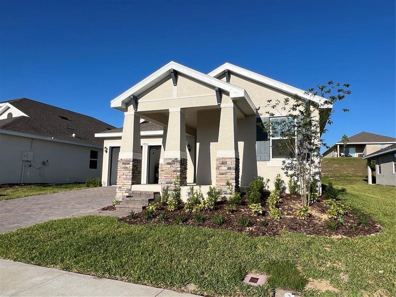 Front exterior of a new home in Hills of Minneola, Minneola, FL, highlighting curb appeal (Image 2). Front exterior of a new home in Hills of Minneola, Minneola, FL, highlighting curb appeal (Image 2).