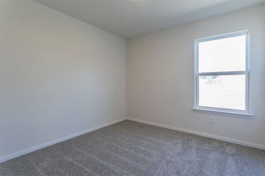 Unfurnished room featuring baseboards and carpet floors Unfurnished room featuring baseboards and carpet floors