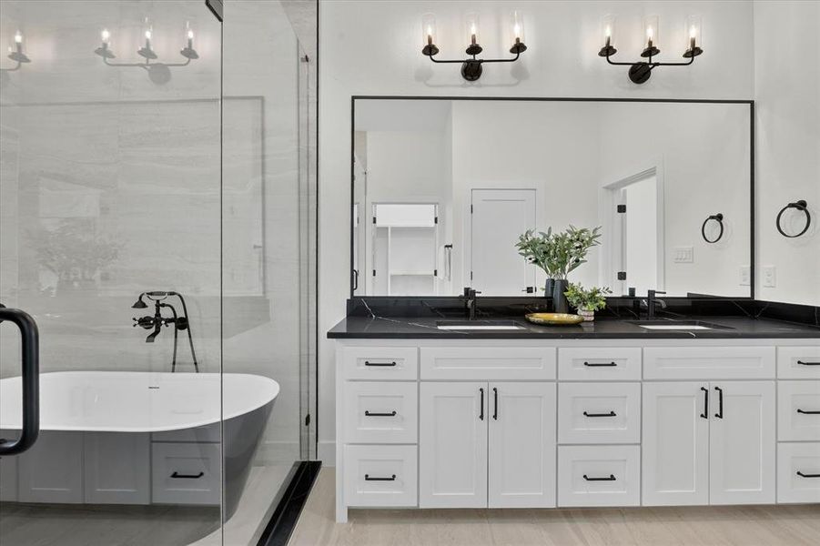 Contemporary bathroom featuring a freestanding soaking tub, a frameless glass shower enclosure, a%2
