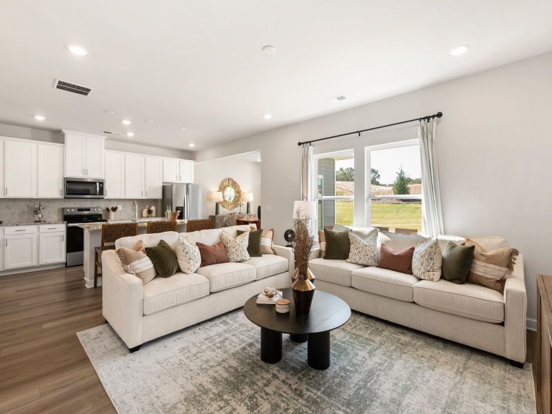 Large windows allow light to flood into the open-concept living space.