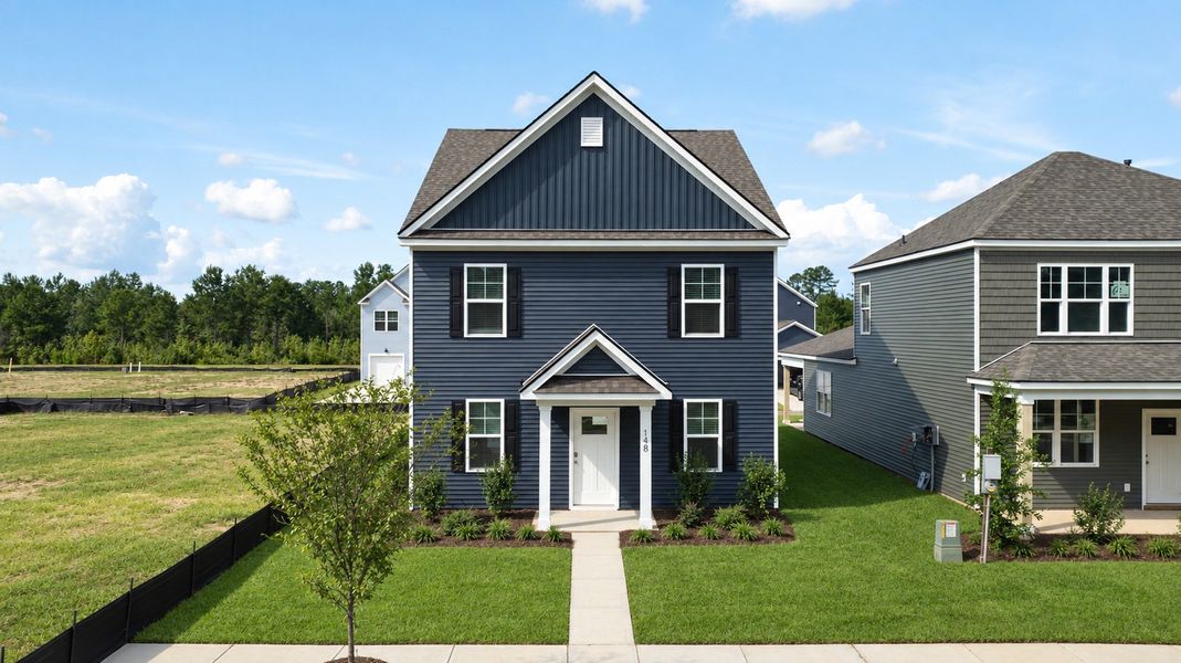 Front exterior of a new home in The Cove at Mallard Crossing, Summerville, SC, highlighting curb appeal (Image 1). Front exterior of a new home in The Cove at Mallard Crossing, Summerville, SC, highlighting curb appeal (Image 1).