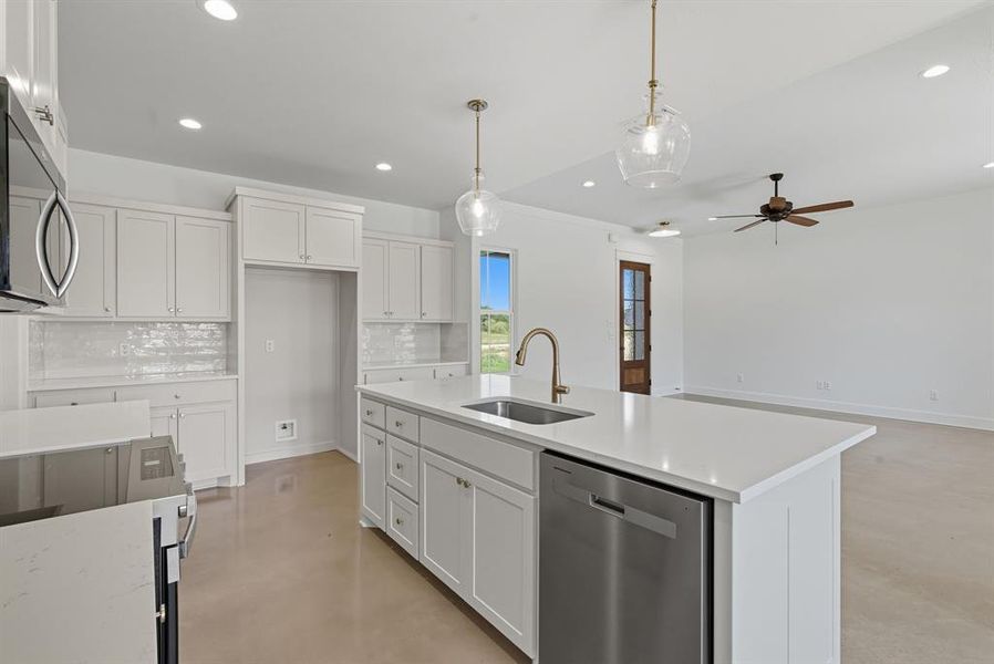 Kitchen featuring stainless steel appliances, decorative backsplash, pendant lighting, white cabinets, and recessed lighting