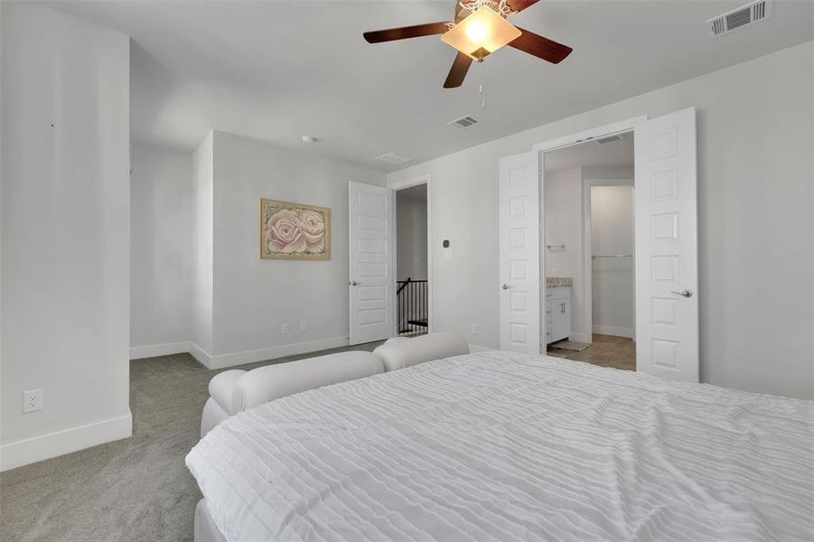 Bedroom with light carpet and ceiling fan