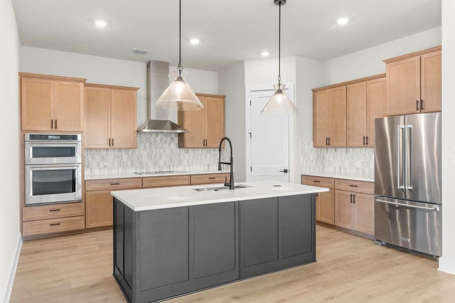 At the center of the Kingsley is a spacious kitchen complete with a large pantry. At the center of the Kingsley is a spacious kitchen complete with a large pantry.