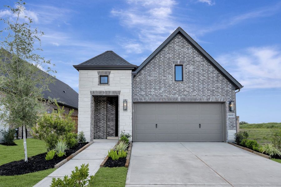 Front exterior of a new home in Sienna - Grove Collection, Missouri City, TX, highlighting curb appeal (Image 2). Front exterior of a new home in Sienna - Grove Collection, Missouri City, TX, highlighting curb appeal (Image 2).
