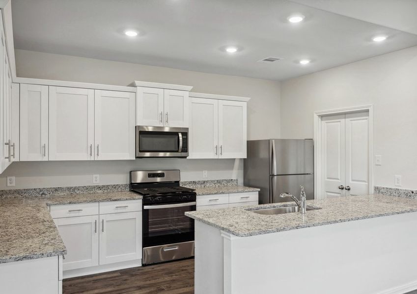 Chef-ready kitchen with white cabinets and granite countertops
