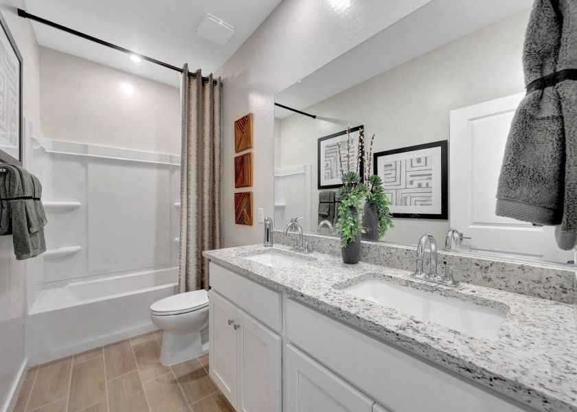 A bathroom with a tub sink and toilet.