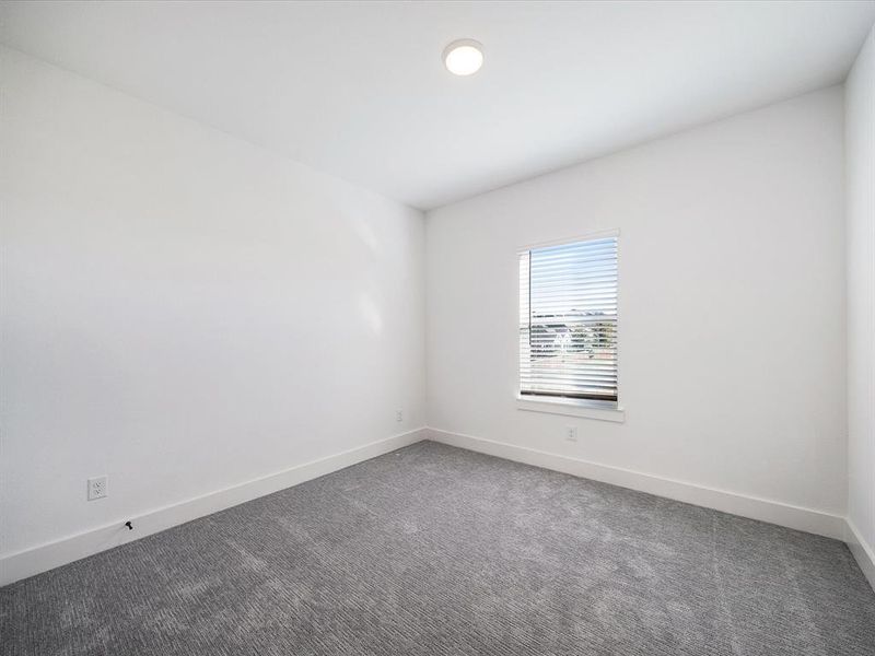 Unfurnished room with carpet and baseboards