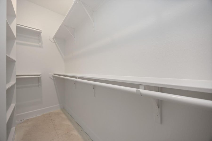 This is just one of two spacious walk-in closets in the primary suite—designed to keep your wardrobe beautifully organized and always within easy reach.