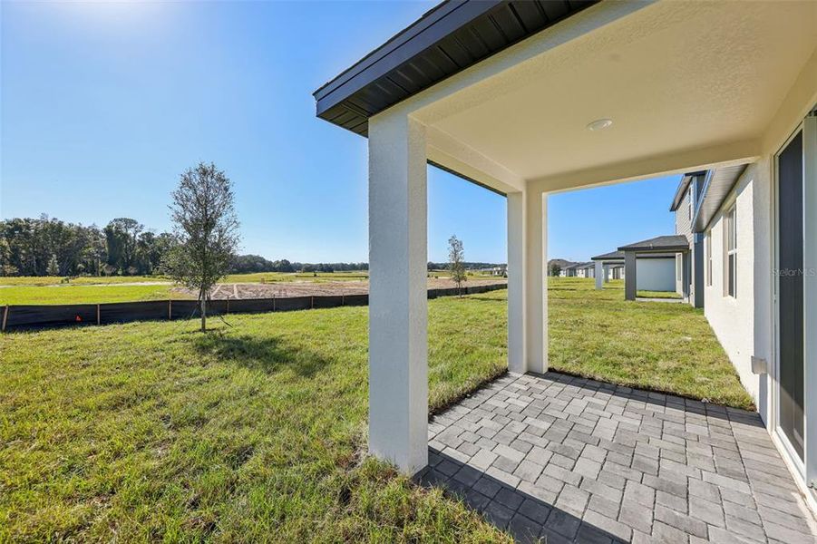 Exterior details and patio area of a home in The Reserve at Hammock Oaks - Signature Series, Lady Lake (Image 4).