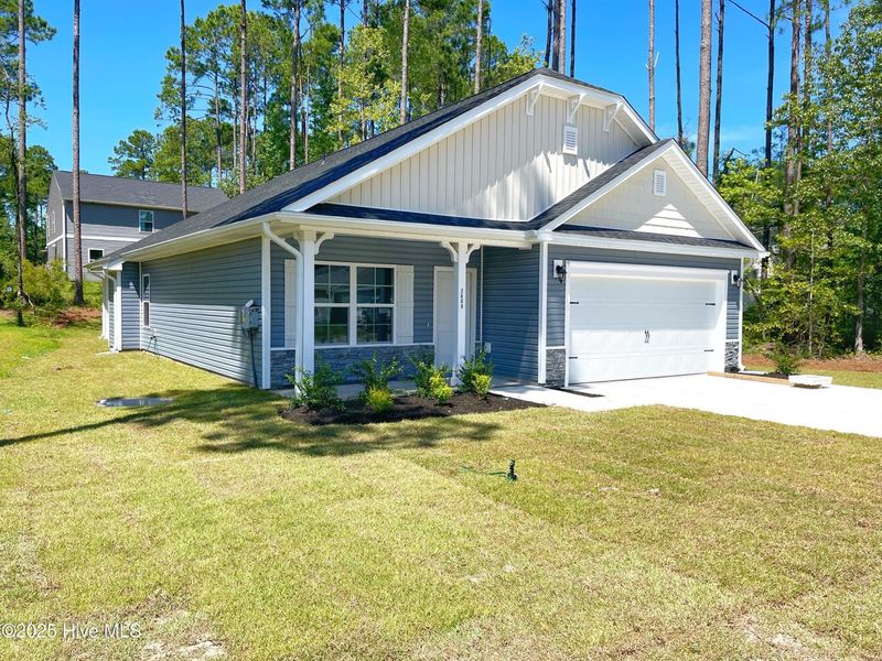 Front exterior of a new home in Mill Creek Cove, Bolivia, NC, highlighting curb appeal (Image 16). Front exterior of a new home in Mill Creek Cove, Bolivia, NC, highlighting curb appeal (Image 16).