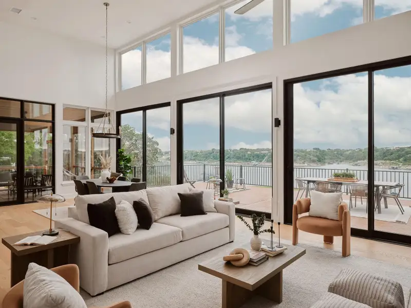 Great room with expansive windows showcasing water frontage