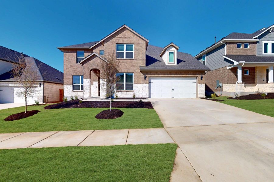 Front exterior of a new home in Edgewood, Leander, TX, highlighting curb appeal (Image 1).