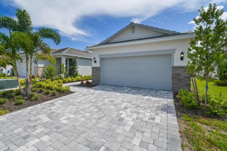 Front exterior of a new home in Harbor Isle, Vero Beach, FL, highlighting curb appeal (Image 29).