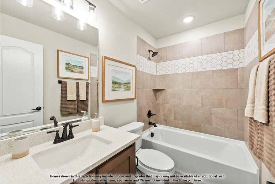 Bathroom with quartz vanity, soaking tub, and beige tile shower with hexagon accent border Bathroom with quartz vanity, soaking tub, and beige tile shower with hexagon accent border
