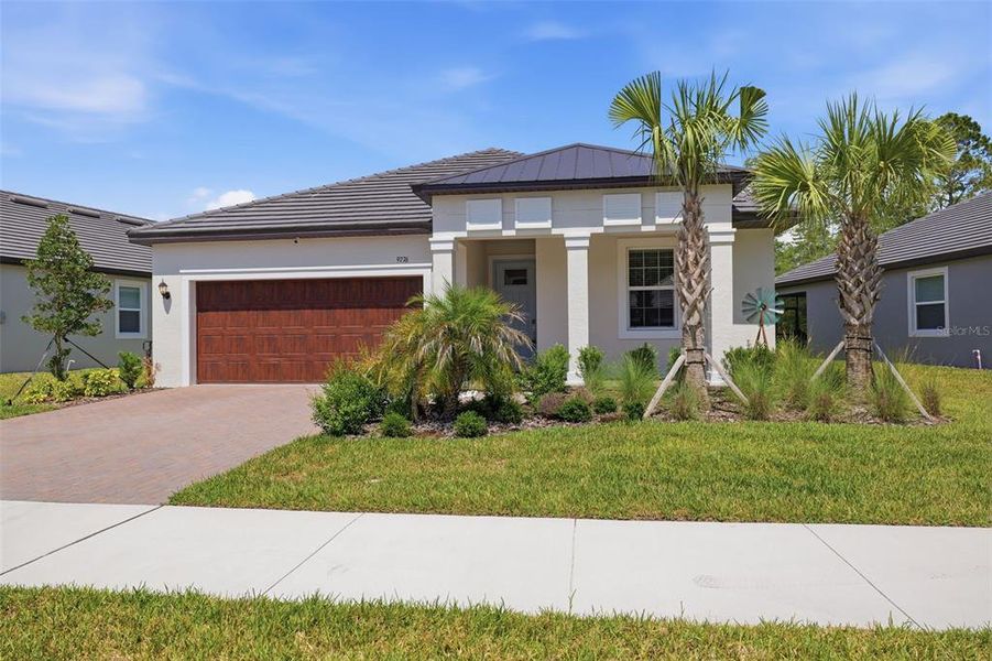 Front exterior of a new home in Angeline Active Adult, Land O' Lakes, FL, highlighting curb appeal (Image 24).