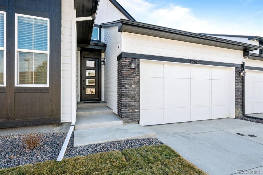 Front exterior of a new home in Deer Creek, Littleton, CO, highlighting curb appeal (Image 1).