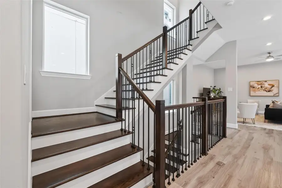 Stairs leading to powder room and third floor Stairs leading to powder room and third floor
