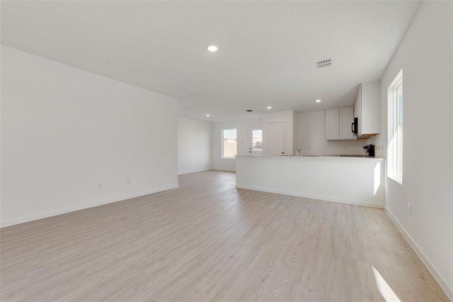 Unfurnished living room featuring light wood-type flooring