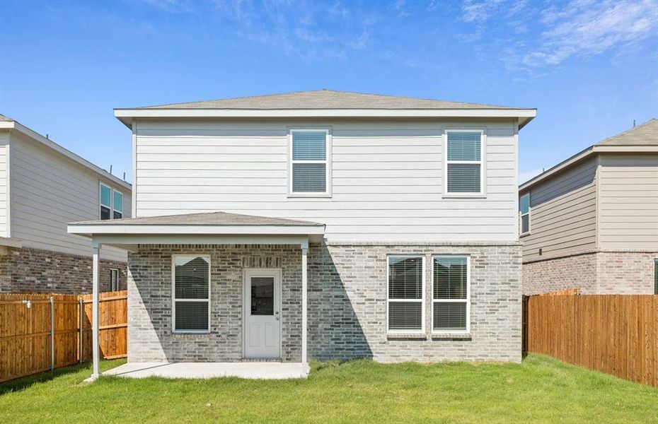 Fenced in backyard with covered patio